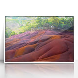 Large art print of a scenic Mauritius landscape in muted greens and blues on a white framed acrylic.