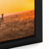 Extra large framed canvas featuring a textured depiction of an African scenery in black with colorful accents.