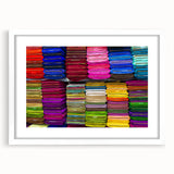 Abstract art print featuring a vibrant, multicolored landscape on a white framed canvas, suitable for dining room decor.