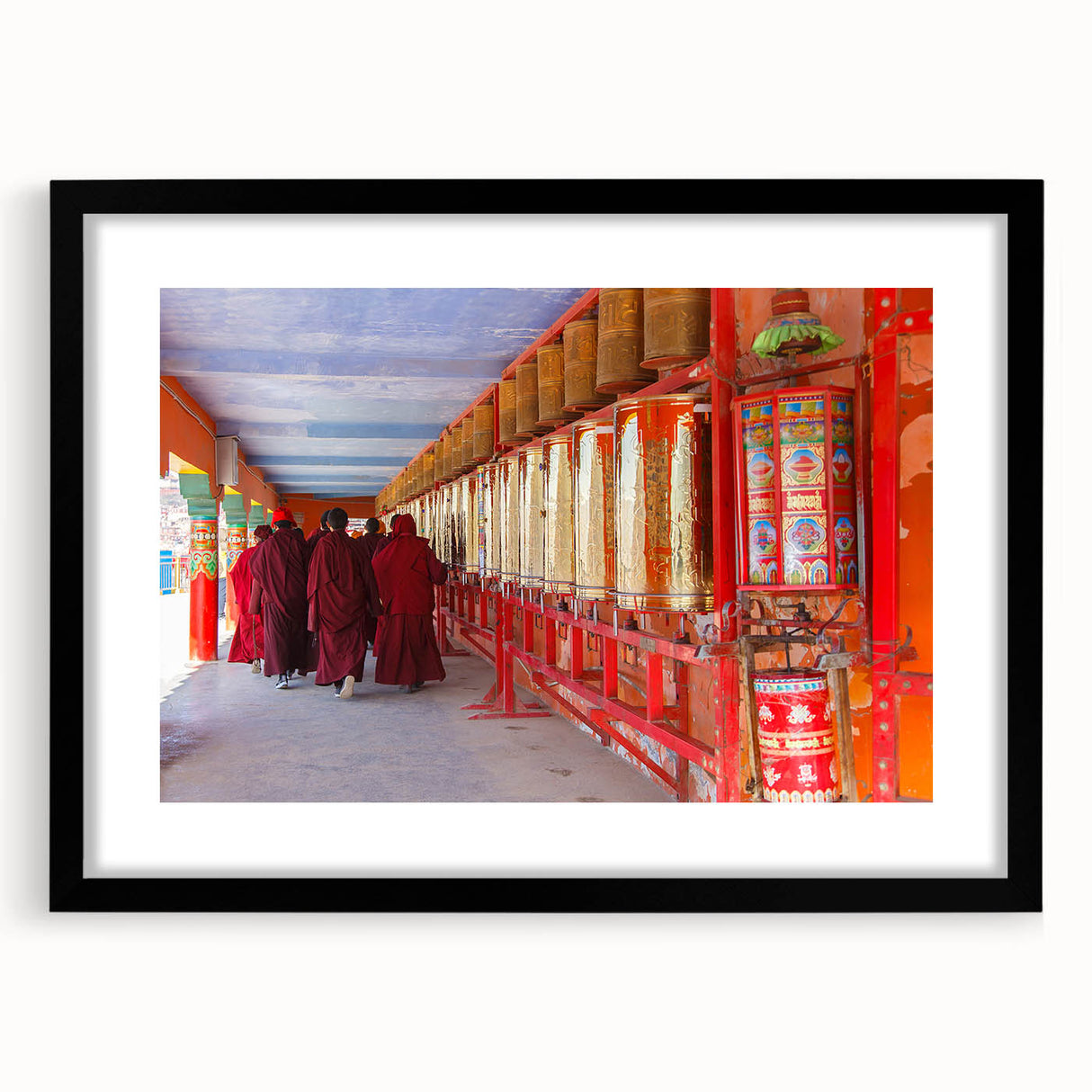 Extra large abstract art print of a colorful Bhutanese landscape on textured canvas, framed in black.