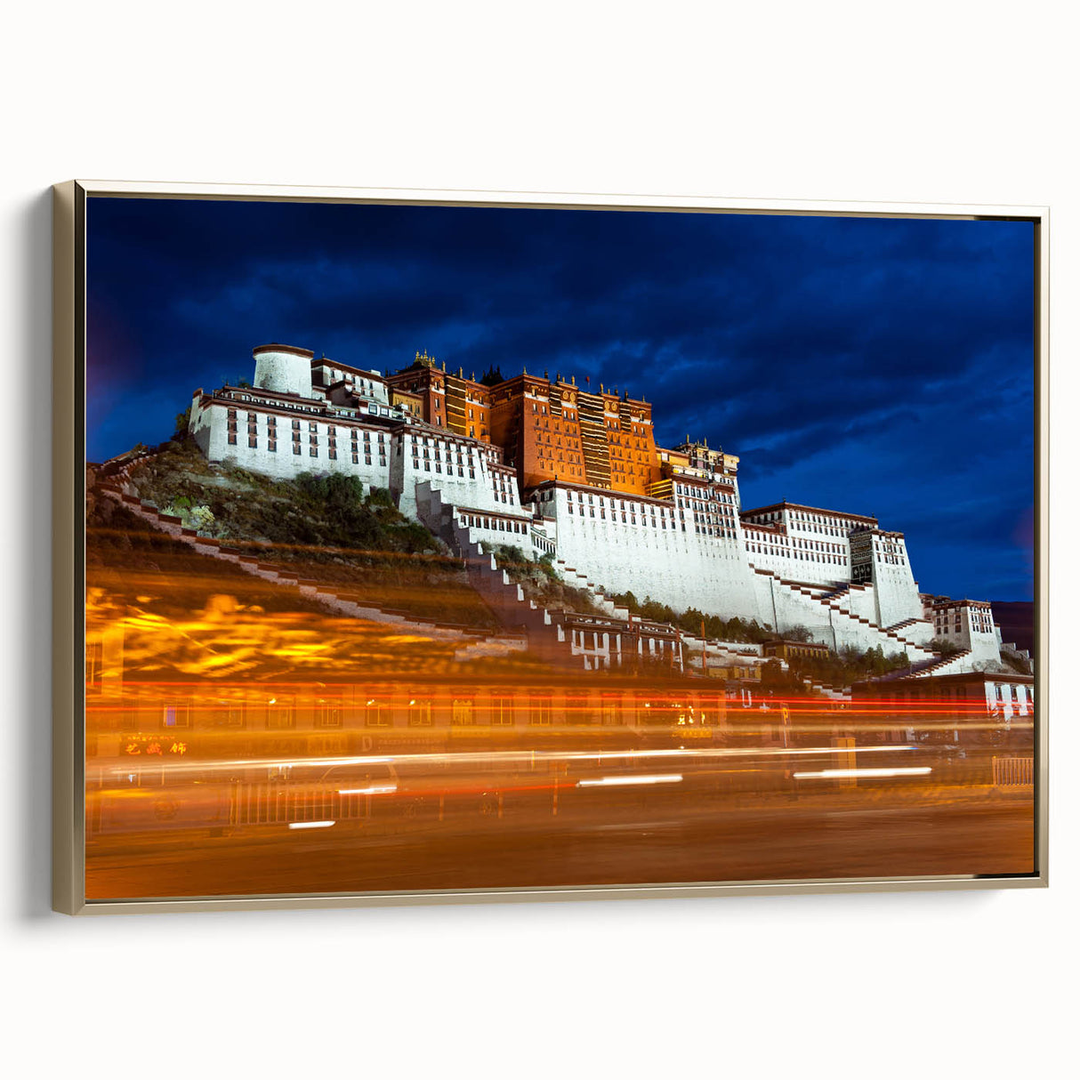 Framed canvas of a Tibetan landscape in muted gold and black, ideal for bedroom wall art.