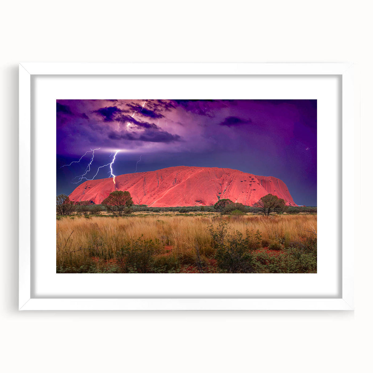 Extra large wall art featuring an abstract print of Ayers Rock in muted orange and brown tones, framed with a white mat.