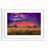 Extra large wall art featuring an abstract print of Ayers Rock in muted orange and brown tones, framed with a white mat.