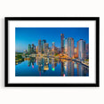 Extra large abstract art print of a colorful Brisbane skyline on a textured canvas, framed in black.