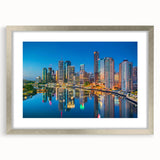 Abstract art print of Brisbane skyline in muted gray and blue tones, framed in silver, ideal for dining room decor.