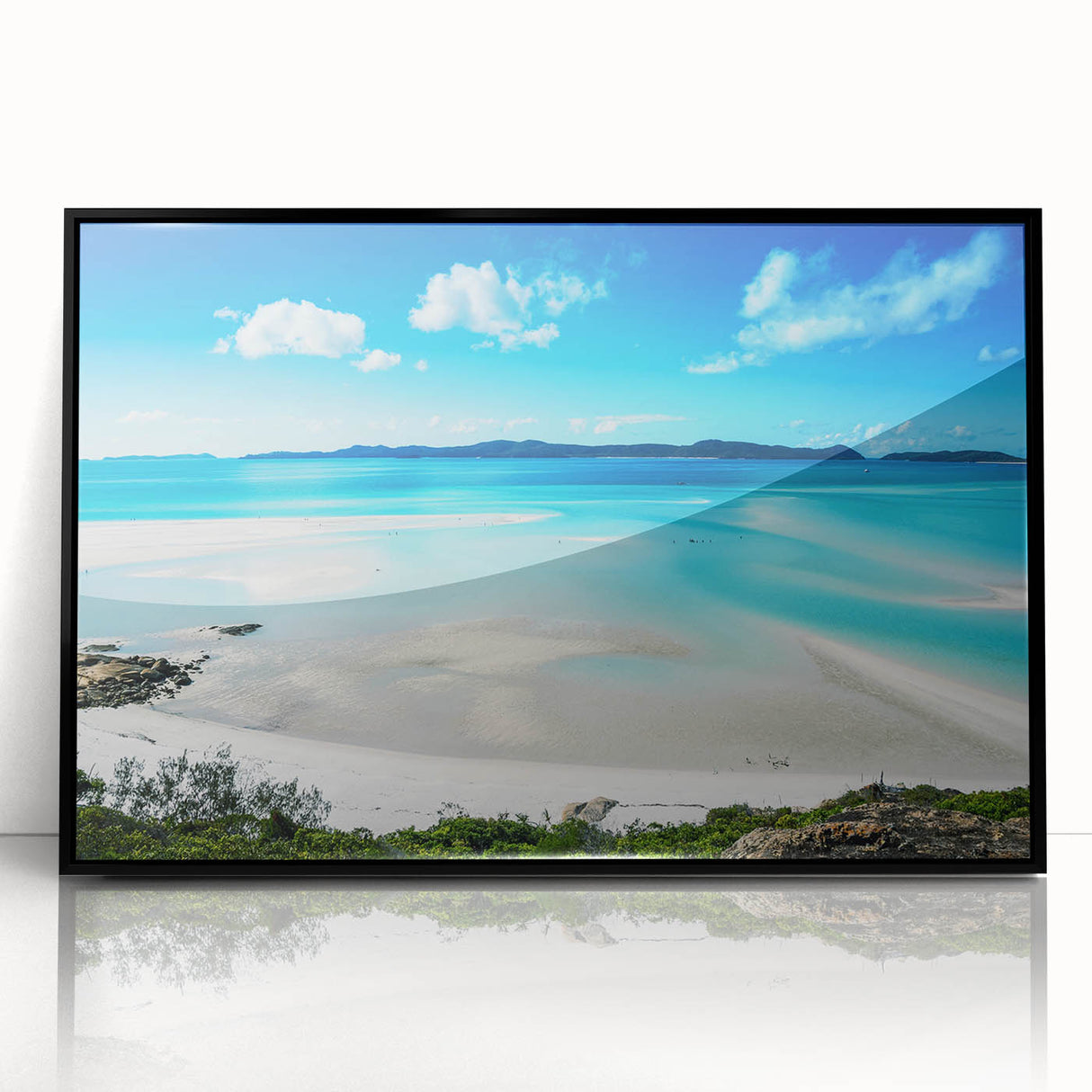Large abstract wall art of the Great Barrier Reef in shades of blue and green, framed in black acrylic.