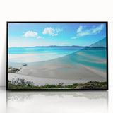 Large abstract wall art of the Great Barrier Reef in shades of blue and green, framed in black acrylic.