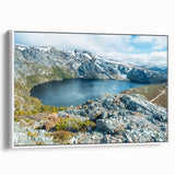 Framed canvas featuring a vintage-style landscape painting of Tasmania with vibrant colors and a black border.