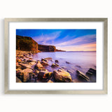 Abstract art print of Newfoundland scenery in muted blue and green tones, framed with a silver mat.