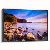 Black and white wall art featuring a vintage landscape painting of Newfoundland on a framed canvas.