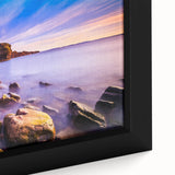 Close-up of a textured black wall art depicting a colorful Newfoundland scenery on a framed canvas.