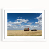 Abstract art print of Saskatchewan scenery in muted green and blue tones, framed with a white mat.