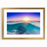 Abstract art print of a Caribbean scenery in muted blue and green tones, framed in gold.