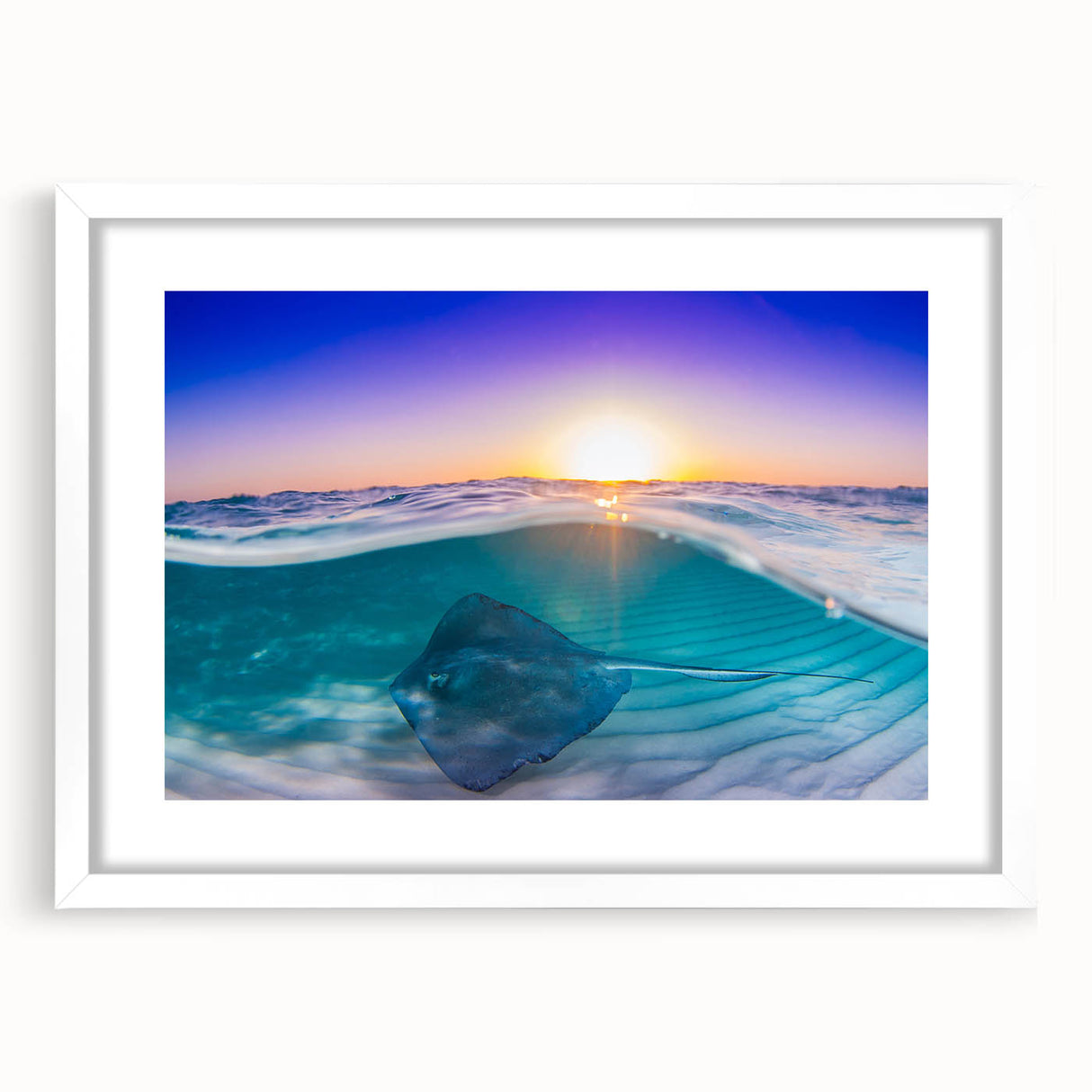 Textured abstract art print depicting a Caribbean seascape in muted blue and green tones, framed with a white mat.