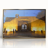 Art deco poster depicting a Caribbean beach scene with palm trees on acrylic print in gold frame.