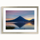 Textured abstract art print of Central American scenery in muted earth tones, framed in silver, ideal for bedroom wall decor.