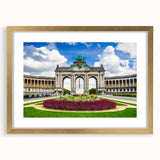 Abstract art print of a European cityscape in muted gold and blue, framed with a gold mat, suitable for dining room decor.