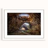 Textured abstract art print depicting a European landscape in muted earth tones on a framed white mat, ideal for bedroom art.