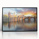 Large abstract wall art depicting a stylized European cityscape in muted gray and blue tones, framed in black acrylic.