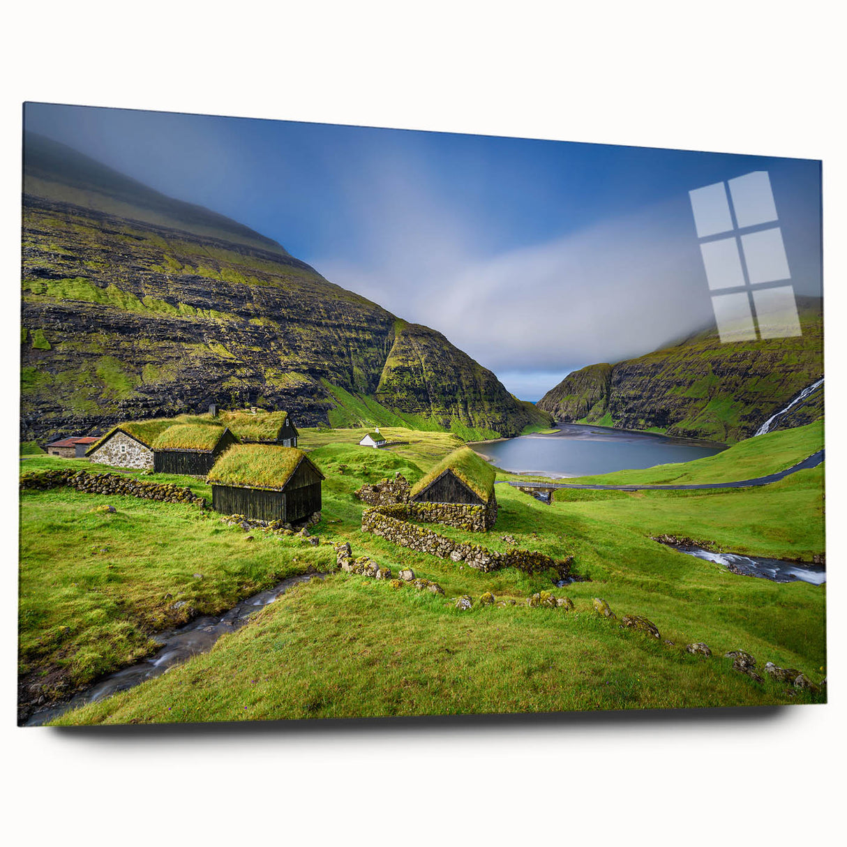 Large abstract wall art of a European scenery in muted blues and greens on acrylic glass.