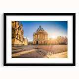 Colorful abstract art print of Oxford scenery in vibrant hues on a black framed canvas, ideal for living room decor.