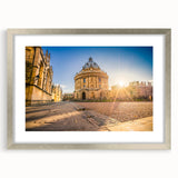 Extra large abstract art print of Oxford scenery in textured shades of gray and blue, framed in silver.