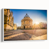 Vintage poster art of Oxford, featuring colorful buildings on black framed canvas, ideal for living room decor.