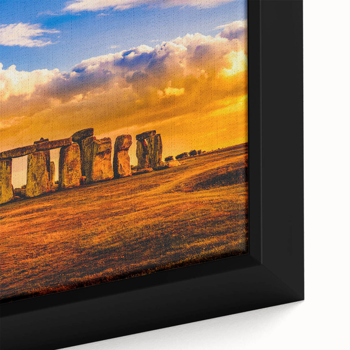 Close-up of black wall art featuring a textured depiction of Stonehenge on a framed canvas, ideal for living room decor.