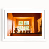 Textured art depicting an abstract European scenery in muted earth tones on a framed white mat, suitable for bedroom art.