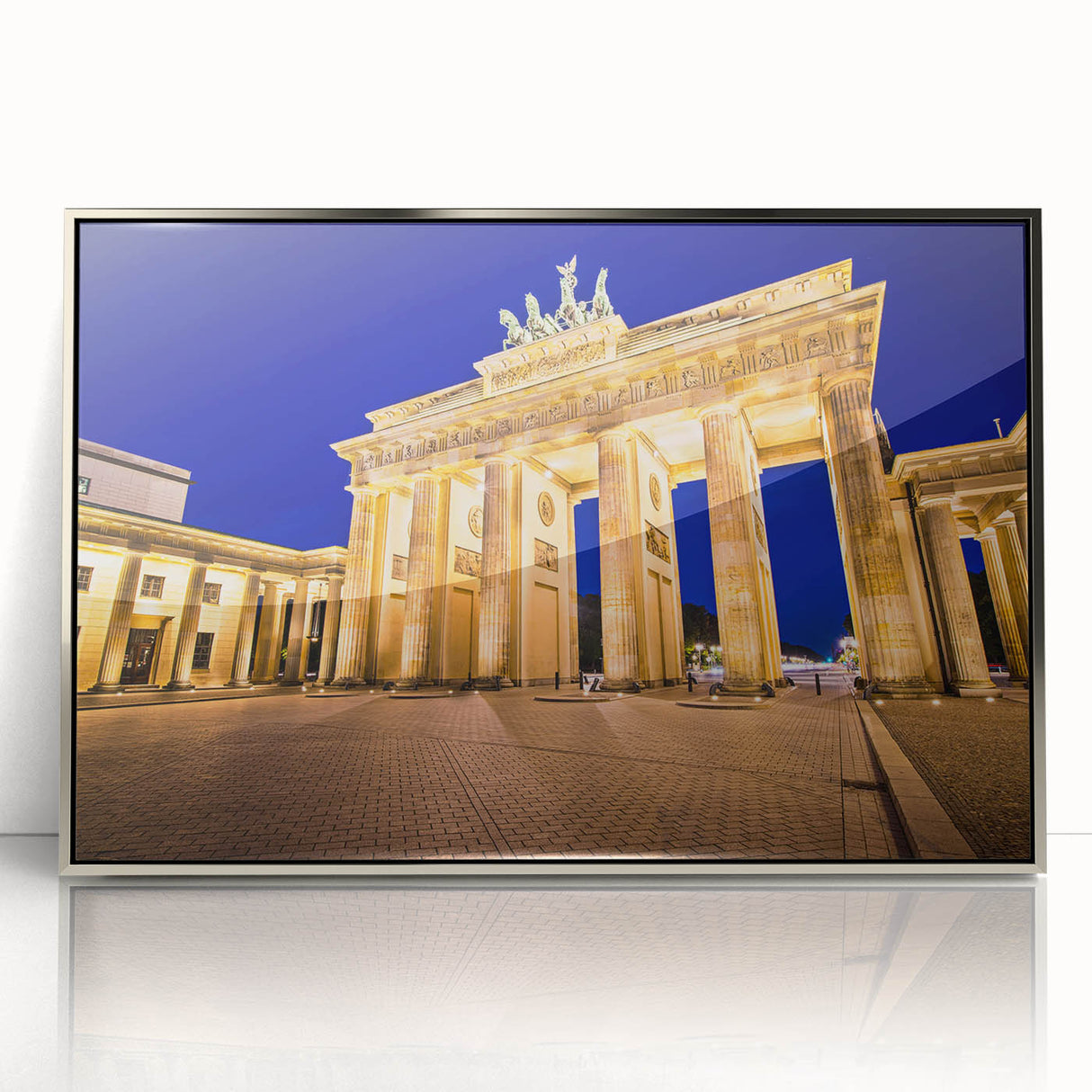 Large art print of Berlin skyline in muted gray and blue tones on a silver-framed acrylic.