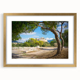 Abstract art print of Athens scenery in muted gold and blue tones, framed with a gold mat, suitable for dining room decor.