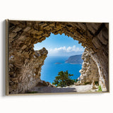 Framed canvas wall art featuring a vintage-style landscape painting of Rhodes, Greece in muted gold and black tones.