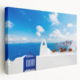 Large art print of Santorini landscape on stretched canvas, showcasing the white buildings and blue domes under a clear sky.