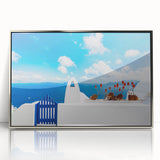 Mid-century modernist art depicting Santorini, Greece, in vibrant blue and white tones on a silver-framed acrylic.