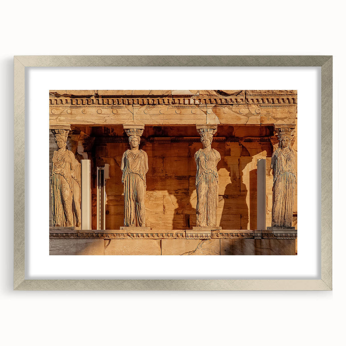 Extra large wall art featuring an abstract depiction of a Greek scenery in muted earth tones, framed in silver.