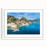 Textured art depicting the Amalfi Coast in muted pastel shades on a framed white mat, suitable for bedroom decor.