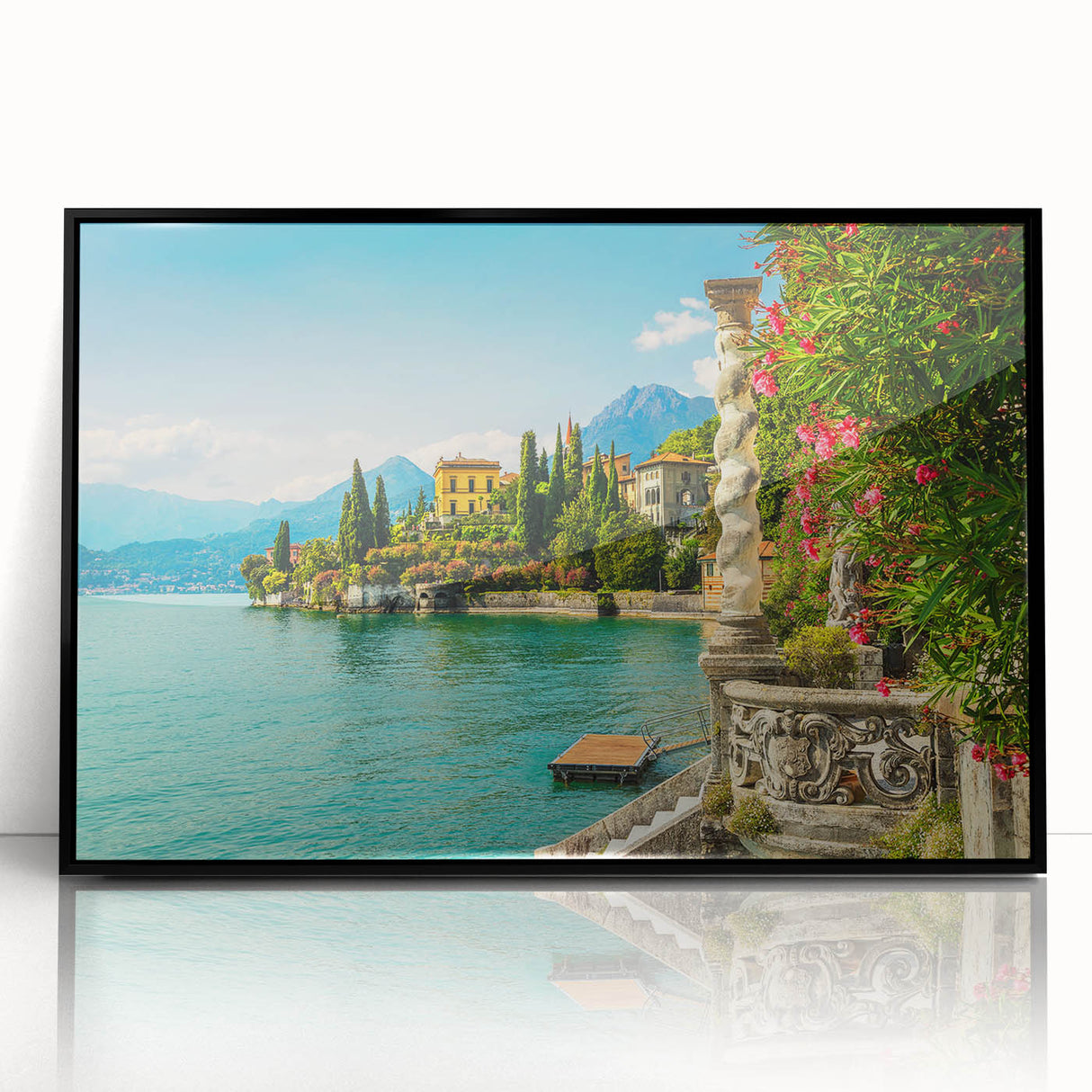 Large abstract wall art of Lake Como in muted blue and green tones, framed in black acrylic.