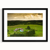 Colorful abstract art print of a European scenery in vibrant hues on a large textured canvas, framed in black.