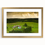Abstract art print of a European landscape in muted earth tones on a gold-framed canvas.