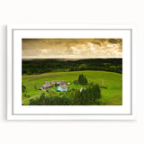 Textured abstract art print of a European scenery in muted earth tones, framed with a white mat, suitable for bedroom decor.