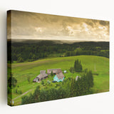 Side view of a stretched canvas depicting a serene Lithuanian landscape in muted green and blue tones.
