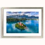 Abstract art print of a European scenery in muted blue and green tones, framed in silver, suitable for dining room decor.