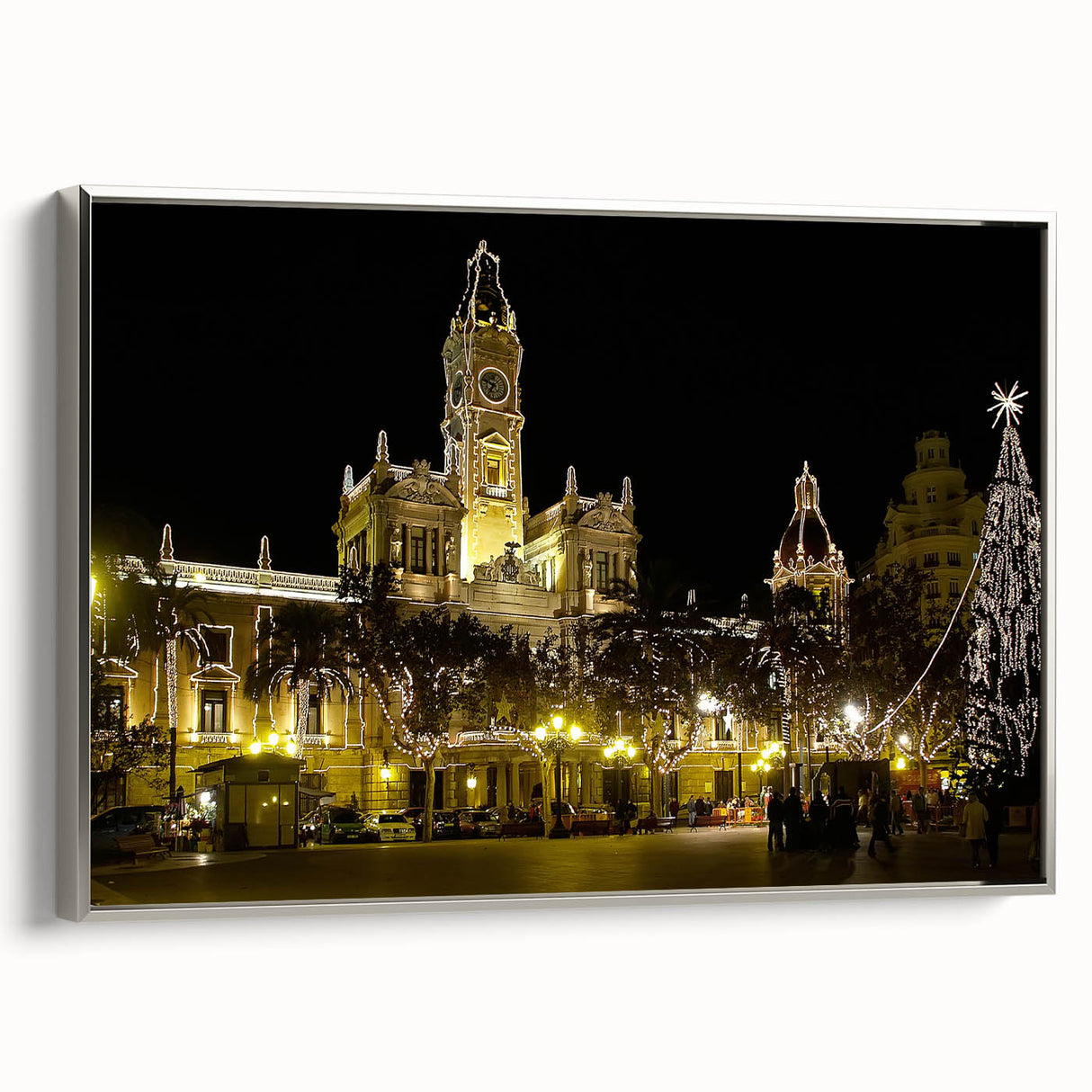 Framed canvas featuring a vintage-style landscape painting of Valencia, with vibrant colors and silver frame.