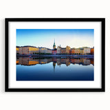Abstract art print of a colorful Stockholm cityscape in vibrant shades on a framed black mat.