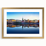 Extra large abstract art print of Stockholm's scenery in muted earth tones on a textured canvas, framed in gold.