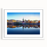 Abstract art print of Stockholm's skyline in muted blue and gray tones on a framed white mat, ideal for dining room decor.