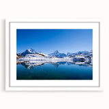 Abstract art print of a European Swiss scene in muted blue and green hues, framed with a white mat.