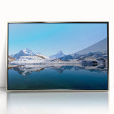 Mid-century modernist art of a serene Swiss landscape in muted green and blue tones, silver-framed acrylic print.