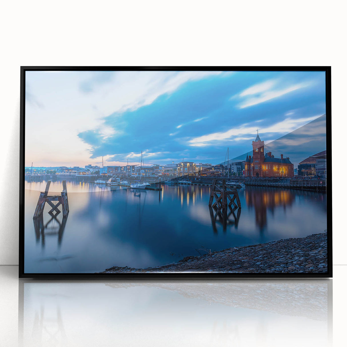 Large abstract wall art depicting a scenic Welsh landscape in muted green and blue tones, framed in black acrylic.