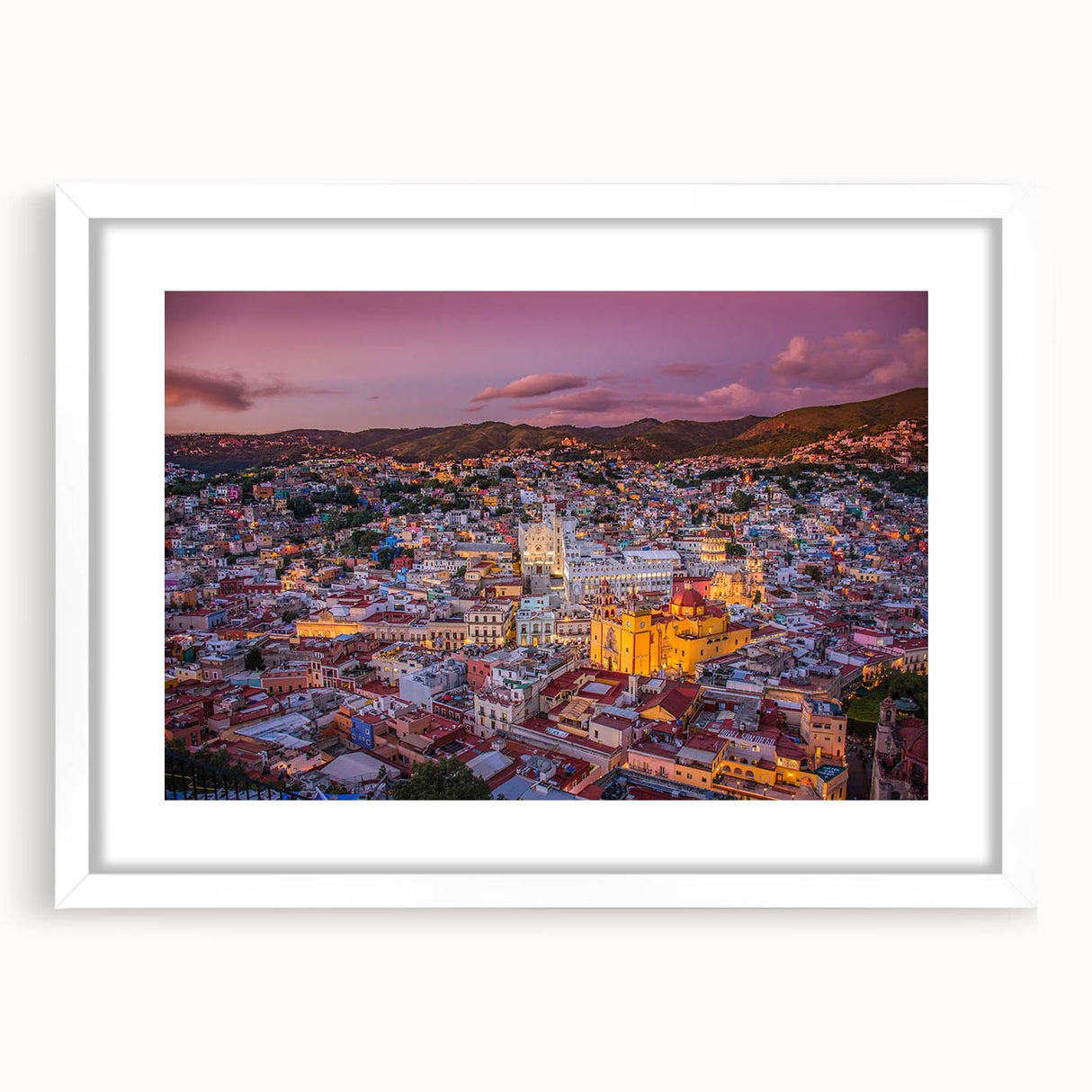 Abstract art print of Guanajuato scenery in vibrant colors on a white framed mat, ideal for dining room decor.